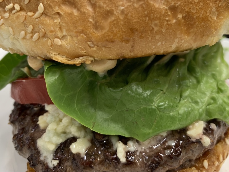 Point Reyes Blue Cheese Burger with Applewood bacon, roasted garlic and rosemary aioli, 
			         little gems, vine-ripe tomatoes, pickled red onions